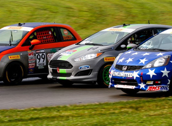 Nathan Stacy (14) battles for position between Austin Snader (99) and Brian Price (51) in TCB Class action. [Andy Clary Photo]