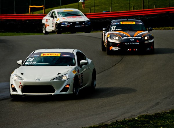 Tony Rivera is chased by Adam Poland in TC class racing action. [Andy Clary Photo]