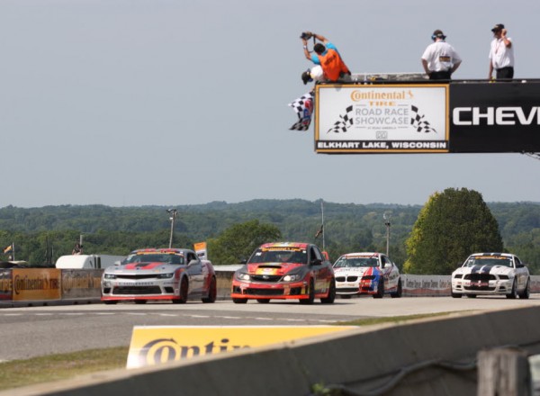 Ryan Liddell passes Pierre Kleinubing for second as the checkers wave.  [Mark Walczak Photo]