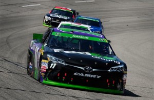 Denny Hamlin leads a pack of cars during the 2015 NASCAR Sprint Cup Series Toyota Owners 400 at Richmond International Raceway. [Credit: Jeff Curry/Getty Images]