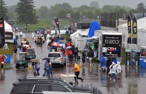 People scurry as rain hits the Indianapolis Motor Speedway, washing out Saturday's scheduled qualifying. [Russ Lake Photo]