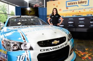 Danica Patrick poses with the new Nature's Bakery #10 Stewart-Haas Racing Chevrolet. [Photo by Jared C. Tilton/Getty Images for Stewart-Haas Racing]