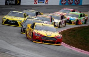 Joey Logano leads a pack of cars at Martinsville Speedway. [Credit: Todd Warshaw/NASCAR via Getty Images]