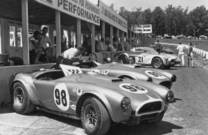 The Shelby team did indeed bring 'Total Performance' to the Watkins Glen USRRC GT Race in June 1964. Pictured is Ken Miles' no. 98 car (CSX2431), which finished first overall; Ed Leslie's no. 99 car (CSX2128), which finished second overall; and independent driver John Everly's no. 21 car (CSX2011), which he crashed through a fence on the first lap with, earning him a DNF. Photo courtesy of Motorbooks