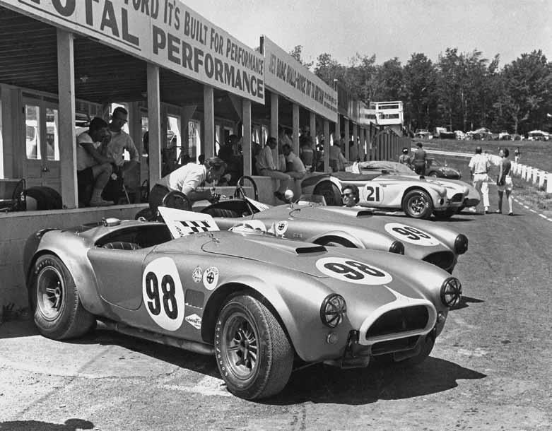 The Shelby team did indeed bring 'Total Performance' to the Watkins Glen USRRC GT Race in June 1964. Pictured is Ken Miles' no. 98 car (CSX2431), which finished first overall; Ed Leslie's no. 99 car (CSX2128), which finished second overall; and independent driver John Everly's no. 21 car (CSX2011), which he crashed through a fence on the first lap with, earning him a DNF. Photo courtesy of Motorbooks