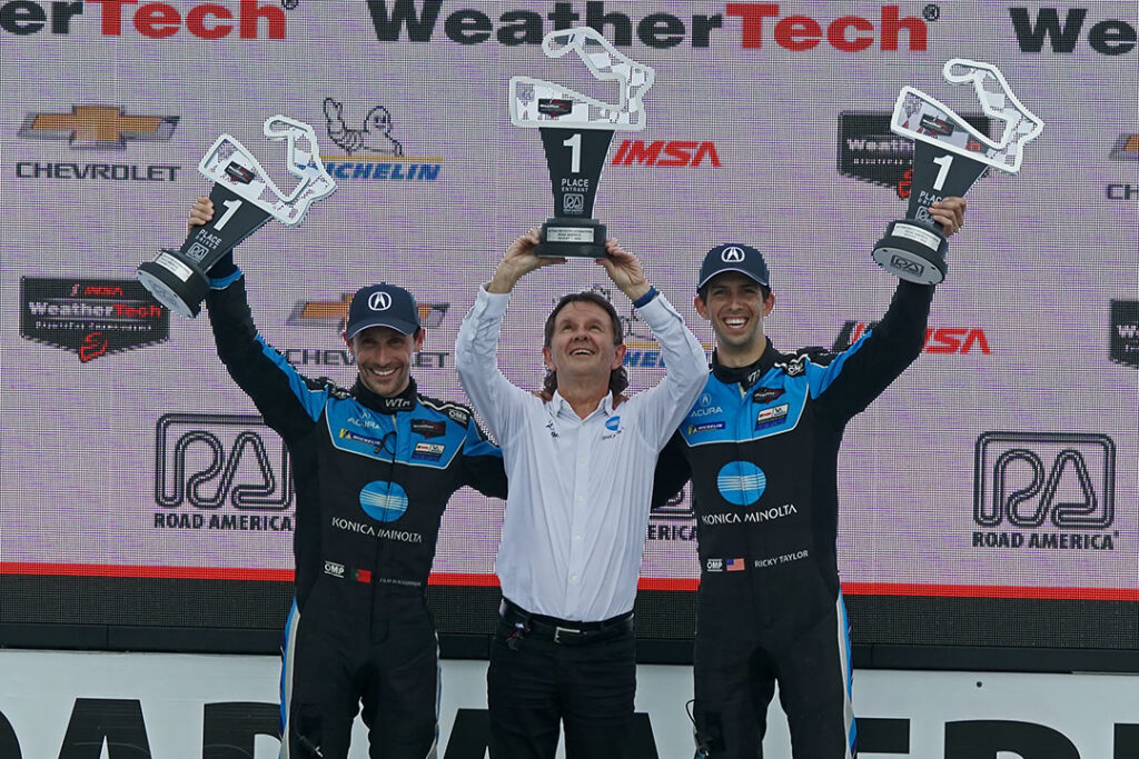 Wayne Taylor (middle) celebrates the Road America win with drivers Filipe Albuquerque and Ricky Taylor. [Pete Gorski Photo]