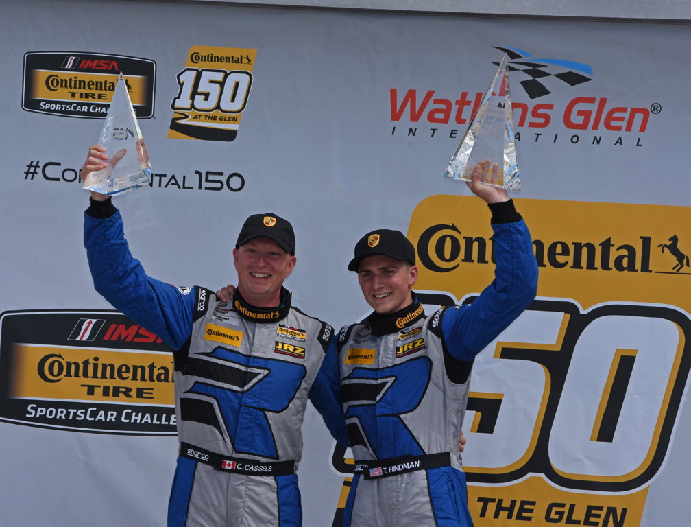 GT class victors Cameron Cassels and Trent Hindman hoist their winning hardware. [Joe Jennings Photo]