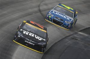 Martin Truex Jr. races Jimmie Johnson during the NASCAR Sprint Cup Series Citizen Solider 400 at Dover International Speedway. [Credit: Sean Gardner/NASCAR via Getty Images]