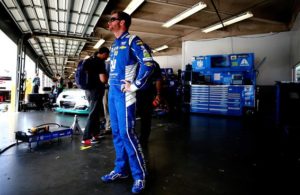 Dale Earnhardt Jr. stands in the garage area during practice for the Monster Energy NASCAR Cup Series 59th Annual Coke Zero 400 Powered By Coca-Cola at Daytona International Speedway. [Photo by Sean Gardner/Getty Images]