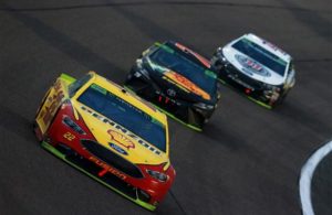 Joey Logano leads Martin Truex Jr. and Kevin Harvick during the Monster Energy NASCAR Cup Series Ford EcoBoost 400 at Homestead-Miami Speedway. [Credit: Sean Gardner/Getty Images]