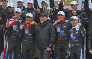 Victory lane ceremonies took place outside in the rain - l to r - Jordan Taylor, Fernando Alonso, Renger van der Zende and Kamui Kubayashi. [Joe Jennings Photo]