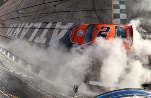 Brad Keselowski celebrates with a burnout after winning the Monster Energy NASCAR Cup Series Folds of Honor QuikTrip 500 at Atlanta Motor Speedway. [Sean Gardner/Getty Images]