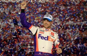 Denny Hamlin celebrates in Victory Lane after winning the NASCAR Cup Series 62nd Annual Daytona 500 at Daytona International Speedway. [Credit: Chris Graythen | Getty Images]