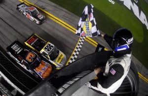 Grant Enfinger (#98) crosses the finish line ahead of Jordan Anderson to win the NASCAR Gander RV & Outdoors Truck Series NextEra Energy 250 at Daytona International Speedway. [Credit: Jared C. Tilton/Getty Images]