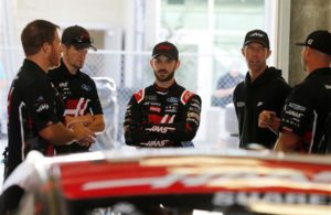 Daniel Suarez stands in the garage during practice for the Monster Energy NASCAR Cup Series Big Machine Vodka 400 at Indianapolis Motor Speedway. [Brian Lawdermilk/Getty Images]