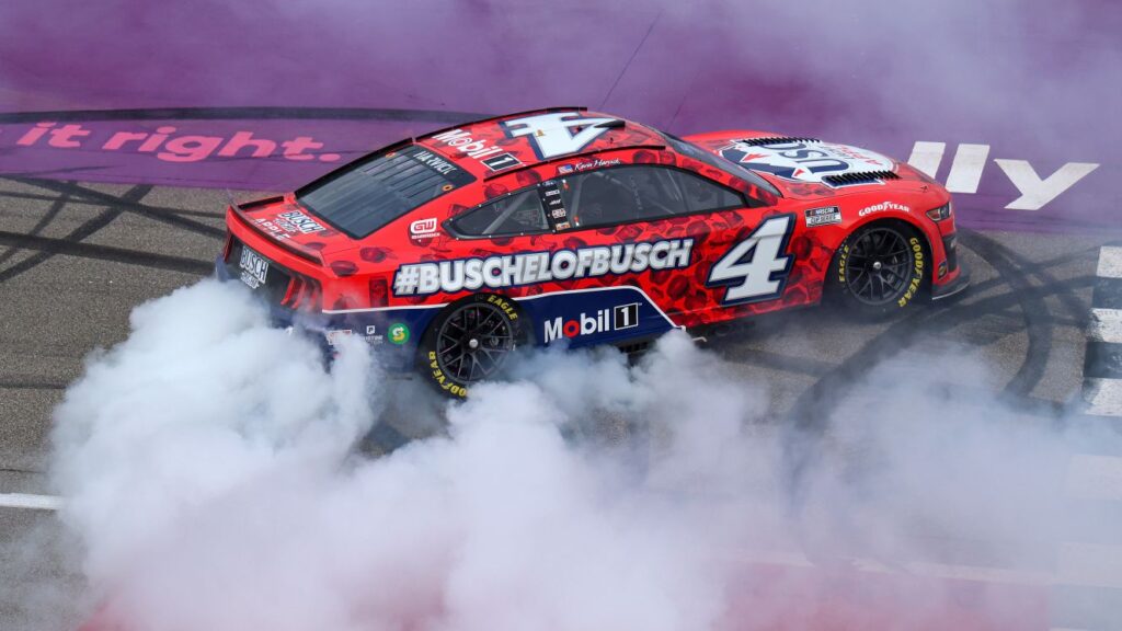 Kevin Harvick celebrates with a burnout after winning the NASCAR Cup Series FireKeepers Casino 400 at Michigan International Speedway. [Photo by Mike Mulholland/Getty Images]