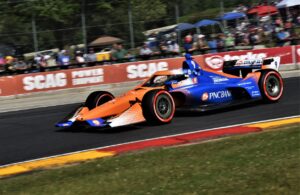 Scott Dixon races past the fans in turn five at Road America. [John Wiedemann Photo]