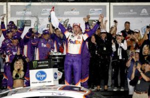 Denny celebrates in Victory Lane after winning the Monster Energy NASCAR Cup Series 61st Annual Daytona 500 at Daytona International Speedway. [Chris Graythen/Getty Images]