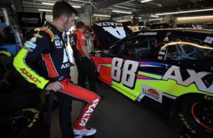 Alex Bowman stands in the garage by his Hendrick Motorsports Chevrolet. [Credit: Chris Graythen/Getty Images]